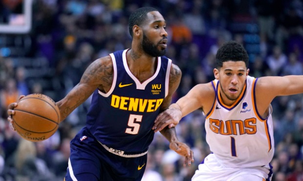 Denver Nuggets guard Will Barton (5) drives past Phoenix Suns guard Devin Booker in the first half ...