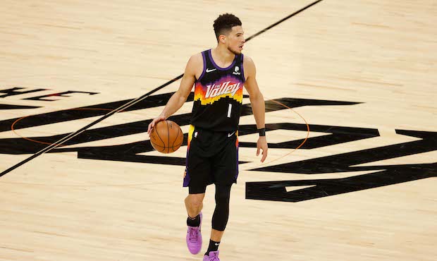 Devin Booker #1 of the Phoenix Suns handles the ball against the Los Angeles Lakers during the seco...