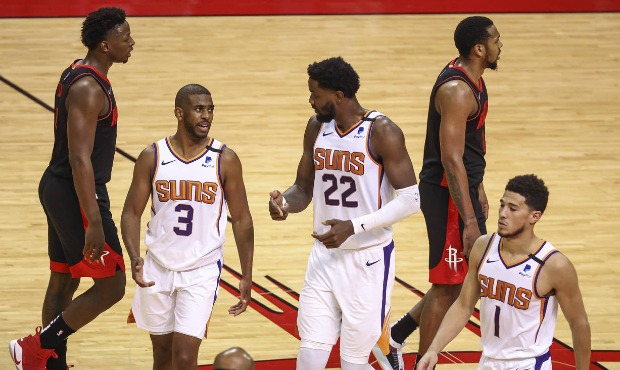 Phoenix Suns guard Chris Paul (3) and center Deandre Ayton (22) talk during a timeout during the fo...