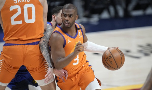 Phoenix Suns guard Chris Paul drives as Denver Nuggets guard Facundo Campazzo is slowed by screen b...