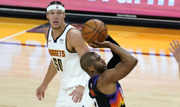 Phoenix Suns guard Chris Paul (3) shoots as Denver Nuggets forward Aaron Gordon (50) looks on durin...