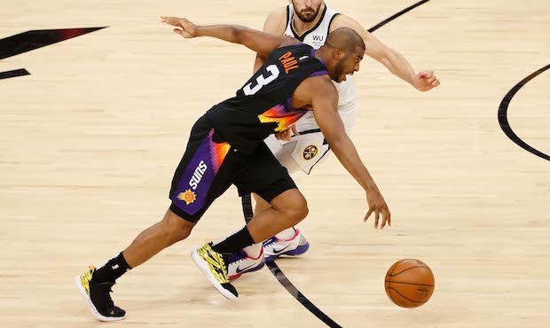 Chris Paul #3 of the Phoenix Suns drives the ball past Facundo Campazzo #7 of the Denver Nuggets du...