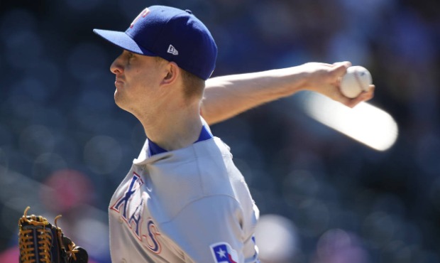 Texas Rangers relief pitcher Brett de Geus works against the Colorado Rockies in the eighth inning ...