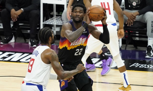 Phoenix Suns center Deandre Ayton (22) shoots as Los Angeles Clippers guard Paul George (13) defend...