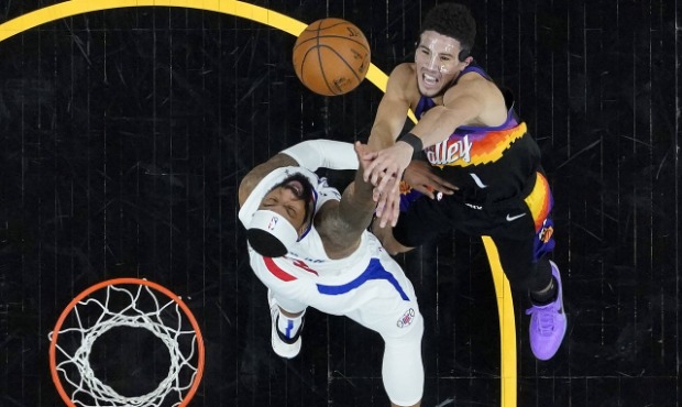 Phoenix Suns guard Devin Booker (1) shoots over Los Angeles Clippers forward Marcus Morris Sr. duri...