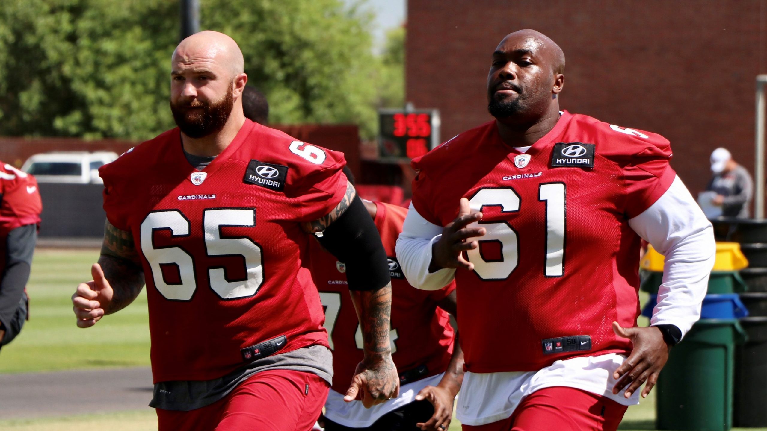 Offensive linemen Brian Winters (left) and Rodney Hudson (right) go through warmups during Day 3 of...