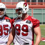 Defensive end J.J. Watt (99) waits in line with Leki Fotu (95) as quarterback Kyler Murray (1) looks on in the background during the Cardinals' first day of mandatory minicamp on Tuesday, June 8, 2021, in Tempe. (Tyler Drake/Arizona Sports)