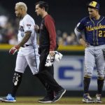 An injured Arizona Diamondbacks' Ketel Marte (4) is helped off the field by Diamondbacks assistant athletic trainer Ryne Eubanks, middle, as Milwaukee Brewers shortstop Willy Adames (27) looks on during the first inning of a baseball game Tuesday, June 22, 2021, in Phoenix. (AP Photo/Ross D. Franklin)