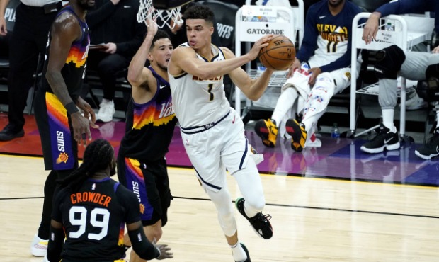 Denver Nuggets forward Michael Porter Jr. (1) looks to pass as Phoenix Suns guard Devin Booker defe...
