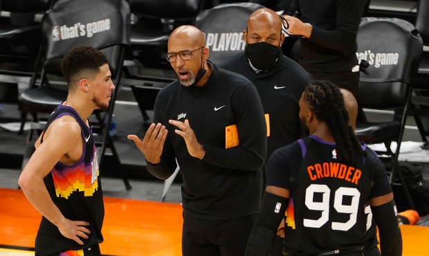Head coach Monty Williams of the Phoenix Suns talks with Devin Booker #1 and Jae Crowder #99 during...