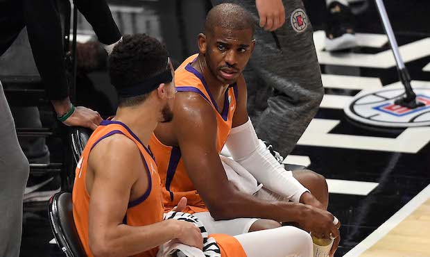 JUNE 26: Chris Paul #3 and Devin Booker #1 of the Phoenix Suns talk on the bench during a time out ...