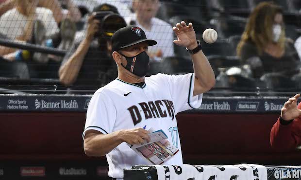 Manager Torey Lovullo #17 of the Arizona Diamondbacks makes a play on a foul ball during the third ...