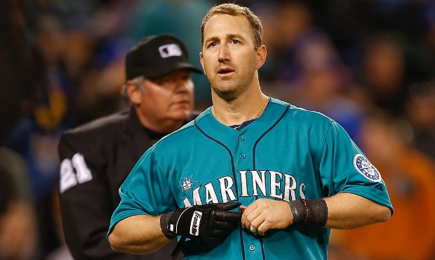 Willie Bloomquist #8 of the Seattle Mariners walks away from home plate umpire Hunter Wendelstedt #...