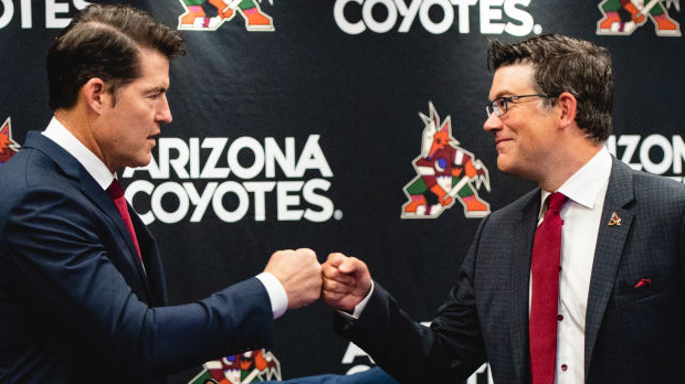 General manager Bill Armstrong of the Arizona Coyotes fist bumps Ryan Jankowski, Associate Director...