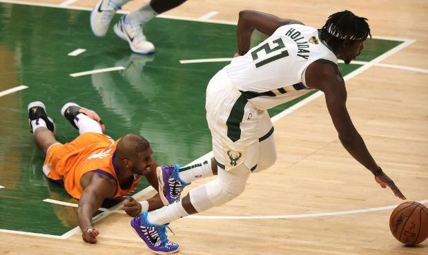 Jrue Holiday #21 of the Milwaukee Bucks steals the ball from Chris Paul #3 of the Phoenix Suns duri...