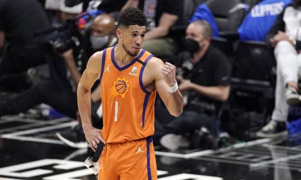 Phoenix Suns' Devin Booker talks to fans as time runs out in Game 6 of the NBA basketball Western C...