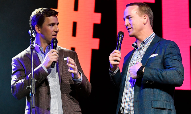 Eli Manning (left) and Peyton Manning (right) speak onstage during the EA Sports Bowl at Bud Light ...