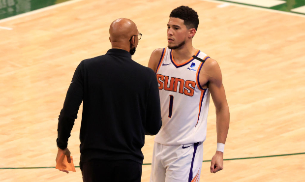 Head coach Monty Williams of the Phoenix Suns talks with Devin Booker #1 during the second half in ...