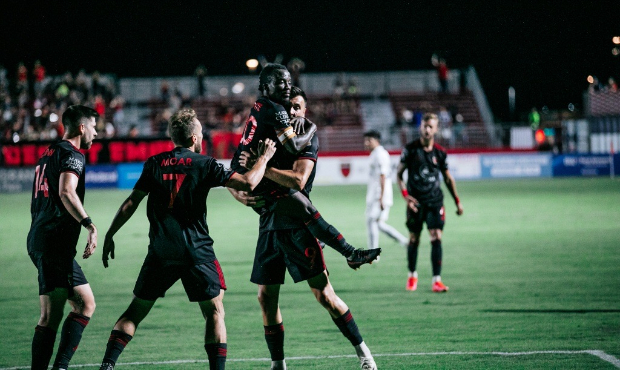 Phoenix Rising captain Solomon Asante celebrates with his teammates after scoring a goal in a 5-0 w...