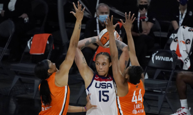 Team WNBA's Candace Parker, left, and Betnijah Laney, right, guard United States' Brittney Griner d...