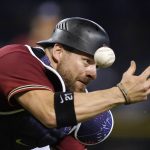 Arizona Diamondbacks catcher Stephen Vogt is unable to make the catch on a foul ball hit by San Francisco Giants' Steven Duggar during the eighth inning of a baseball game Friday, July 2, 2021, in Phoenix. (AP Photo/Ross D. Franklin)