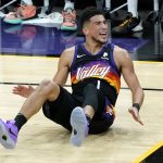 Phoenix Suns guard Devin Booker (1) looks for a call during the first half of Game 1 of basketball's NBA Finals against the Milwaukee Bucks, Tuesday, July 6, 2021, in Phoenix. (AP Photo/Matt York)