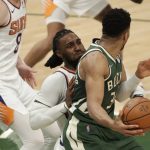 Milwaukee Bucks' Giannis Antetokounmpo, right, backs down Phoenix Suns' Jae Crowder during the second half of Game 3 of basketball's NBA Finals, Sunday, July 11, 2021, in Milwaukee. (AP Photo/Aaron Gash)