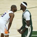 Milwaukee Bucks center Bobby Portis, right, reacts to a basket as Phoenix Suns guard Chris Paul (3) looks on during the second half of Game 3 of basketball's NBA Finals in Milwaukee, Sunday, July 11, 2021. (AP Photo/Paul Sancya)