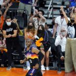 Phoenix Suns fans cheer on Suns guard Chris Paul (3) after he made a 3-pointer against the Milwaukee Bucks during the second half of Game 1 of basketball's NBA Finals, Tuesday, July 6, 2021, in Phoenix. (AP Photo/Ross D. Franklin)