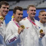 United States men's 4x100m freestyle relay team of, Zach Apple, from left, Blake Pieroni, Bowen Beck, and Caeleb Dressel poses after winning the gold medal at the 2020 Summer Olympics, Monday, July 26, 2021, in Tokyo, Japan. (AP Photo/Petr David Josek)