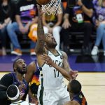 Milwaukee Bucks forward P.J. Tucker (17) scores as Phoenix Suns forward Jae Crowder, back left, Bucks center Bobby Portis, front left, and Suns forward Mikal Bridges, right, look on during the first half of Game 1 of basketball's NBA Finals, Tuesday, July 6, 2021, in Phoenix. (AP Photo/Ross D. Franklin)