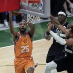 Phoenix Suns forward Mikal Bridges (25) goes to the basket against Milwaukee Bucks forward Giannis Antetokounmpo during the first half of Game 6 of basketball's NBA Finals Tuesday, July 20, 2021, in Milwaukee. (AP Photo/Aaron Gash)