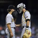 Pittsburgh Pirates starting pitcher Max Kranick, left, talks with catcher Jacob Stallings during the fourth inning of the team's baseball game against the Arizona Diamondbacks, Wednesday, July 21, 2021, in Phoenix. (AP Photo/Ross D. Franklin)