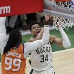 Milwaukee Bucks forward Giannis Antetokounmpo (34) shoots over Phoenix Suns forward Jae Crowder (99) during the second half of Game 4 of basketball's NBA Finals Wednesday, July 14, 2021, in Milwaukee. (AP Photo/Aaron Gash)