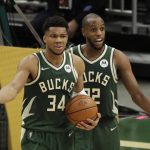 Milwaukee Bucks' Giannis Antetokounmpo (34) and Khris Middleton react to a call during the second half of Game 3 of basketball's NBA Finals against the Phoenix Suns, Sunday, July 11, 2021, in Milwaukee. (AP Photo/Aaron Gash)