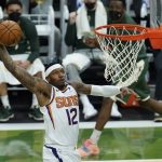 Phoenix Suns' Torrey Craig (12) dunks during the first half of Game 3 of basketball's NBA Finals against the Phoenix Suns in Milwaukee, Sunday, July 11, 2021. (AP Photo/Paul Sancya)