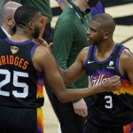 Phoenix Suns forward Mikal Bridges (25) celebrates with guard Chris Paul (3) after the Suns defeated the Milwaukee Bucks in Game 2 of basketball's NBA Finals, Thursday, July 8, 2021, in Phoenix. (AP Photo/Ross D. Franklin)