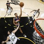 Phoenix Suns' Cameron Payne (15) shoots over Milwaukee Bucks' Pat Connaughton (24) during the first half of Game 1 of basketball's NBA Finals, Tuesday, July 6, 2021, in Phoenix. (Christian Petersen/Pool Photo via AP)