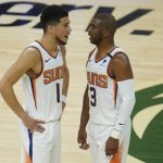 
              Phoenix Suns' Chris Paul (3) talks with Devin Booker (1) during the first half of Game 3 of basketball's NBA Finals against the Milwaukee Bucks, in Milwaukee, Sunday, July 11, 2021. (AP Photo/Paul Sancya)
            