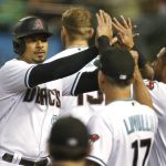 
              Arizona Diamondbacks' Eduardo Escobar, left, is congratulated by manager Torey Lovullo (17) and David Peralta (6) after scoring a run against the Colorado Rockies on a double by Christian Walker during the first inning of a baseball game, Tuesday, July 6, 2021, in Phoenix. (AP Photo/Ralph Freso)
            