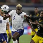 
              United States forward Gyasi Zardes (9) and Jamaica's Oniel Fisher (8) chase after a loose ball in the second half of a CONCACAF Gold Cup quarterfinals soccer match, Sunday, July 25, 2021, in Arlington, Texas. (AP Photo/Brandon Wade)
            