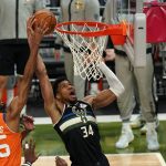 Milwaukee Bucks forward Giannis Antetokounmpo (34) goes to the basket against Phoenix Suns forward Mikal Bridges (25) during the second half of Game 6 of basketball's NBA Finals in Milwaukee, Tuesday, July 20, 2021. (AP Photo/Paul Sancya)