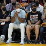Arizona Cardinals wide receiver Larry Fitzgerald, second from left, watches Game 2 of basketball's NBA Finals between the Phoenix Suns and the Milwaukee Bucks, Thursday, July 8, 2021, in Phoenix. (AP Photo/Ross D. Franklin)
