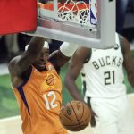 Phoenix Suns forward Torrey Craig (12) dunks the ball during the first half against the Milwaukee Bucks in Game 4 of basketball's NBA Finals Wednesday, July 14, 2021, in Milwaukee. (AP Photo/Aaron Gash)