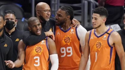 Phoenix Suns head coach Monty Williams, second from left, hugs Chris Paul, left, and Jae Crowder, s...