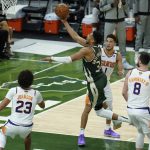Milwaukee Bucks' Giannis Antetokounmpo (34) puts up a shot during the first half of Game 3 of basketball's NBA Finals against the Phoenix Suns in Milwaukee, Sunday, July 11, 2021. (AP Photo/Paul Sancya)