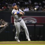 
              Los Angeles Dodgers third baseman Justin Turner makes an off-balance throw for the out on a ball hit by Arizona Diamondbacks' Nick Ahmed during the seventh inning of a baseball game Friday, July 30, 2021, in Phoenix. (AP Photo/Rick Scuteri)
            