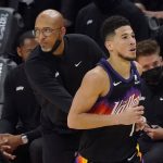 Phoenix Suns guard Devin Booker, right, jogs past head coach Monty Williams after shooting a three point basket during the second half of Game 2 of basketball's NBA Finals against the Milwaukee Bucks, Thursday, July 8, 2021, in Phoenix. (AP Photo/Matt York)