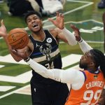 Milwaukee Bucks forward Giannis Antetokounmpo (34) battles for the ball against Phoenix Suns forward Jae Crowder (99) during the first half of Game 6 of basketball's NBA Finals in Milwaukee, Tuesday, July 20, 2021. (AP Photo/Paul Sancya)