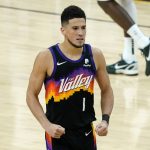 Phoenix Suns guard Devin Booker (1) pumps his fists after a basket against the Milwaukee Bucks during the second half of Game 1 of basketball's NBA Finals, Tuesday, July 6, 2021, in Phoenix. (AP Photo/Matt York)
